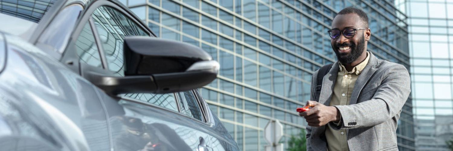 Un homme ouvre sa voiture avec sa clé télécommandée