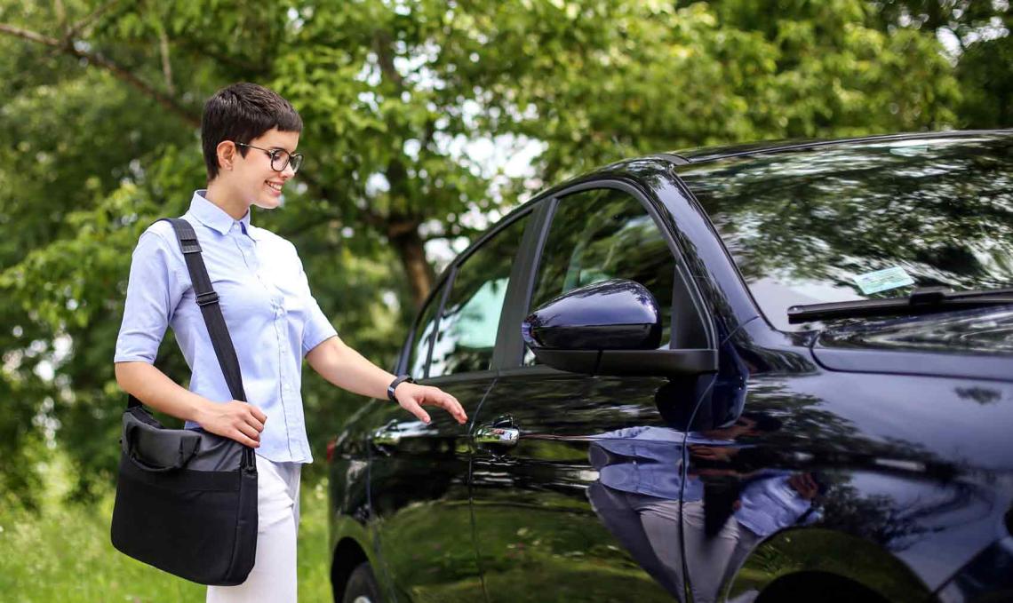 Une femme se dirige vers la portière de sa voiture