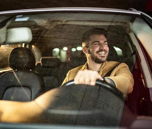 Un homme sourit en conduisant